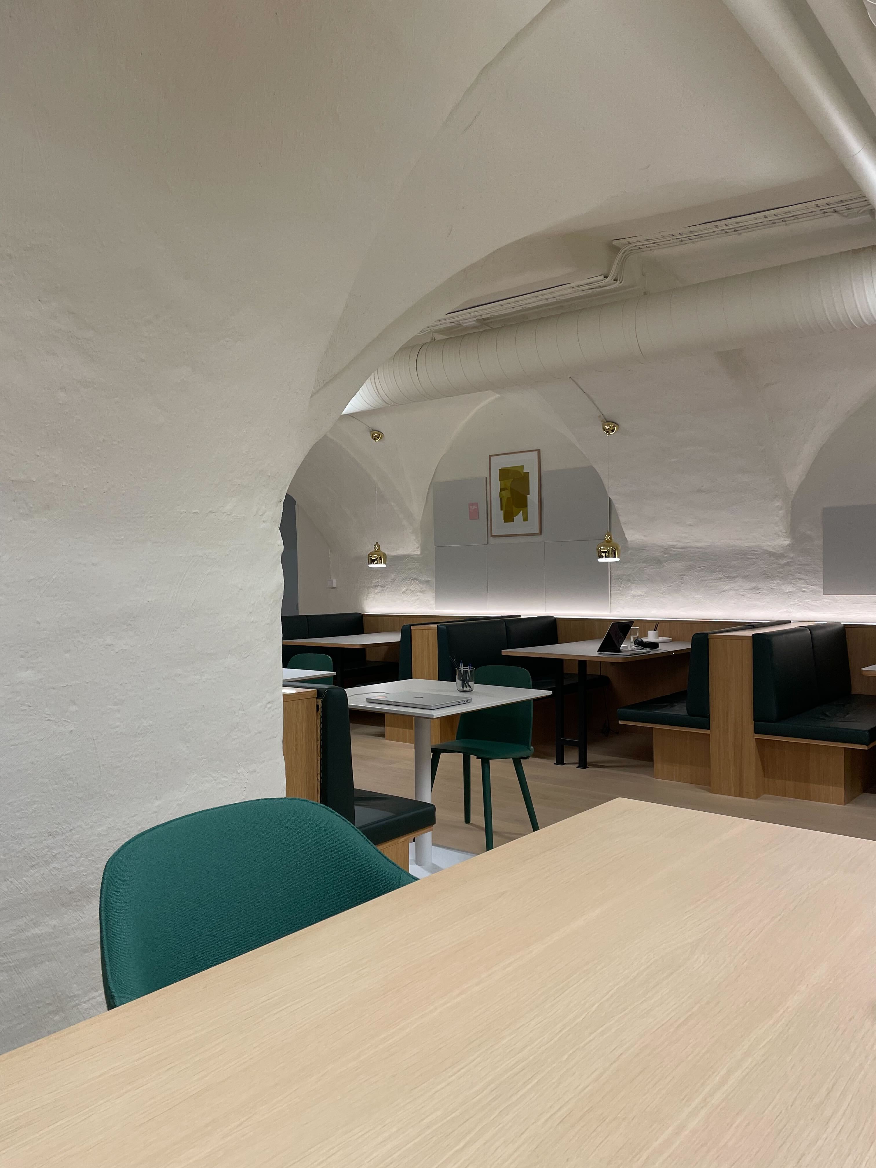 One of Spaces' locations in the old town of Stockholm, where BlueCall has its office. The office is furnished with desks, chairs and white walls.